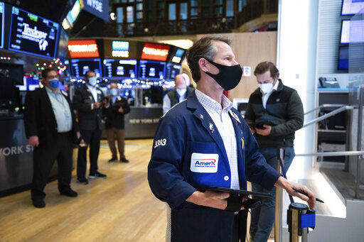 In this photo provided by the New York Stock Exchange, traders work on the floor, Tuesday, Jan. 5, 2021. U.S. stocks are wobbling between small gains and losses on Tuesday, a day after dropping to their worst loss in months amid the worsening pandemic and potentially market-moving Senate elections. (Colin Ziemer/New York Stock Exchange via AP) PHOTO CREDIT: Colin Ziemer