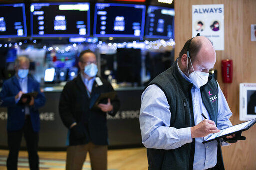 In this photo provided by the New York Stock Exchange, traders work on the floor, Tuesday, Jan. 5, 2021. U.S. stocks are wobbling between small gains and losses on Tuesday, a day after dropping to their worst loss in months amid the worsening pandemic and potentially market-moving Senate elections. (Colin Ziemer/New York Stock Exchange via AP) PHOTO CREDIT: Colin Ziemer