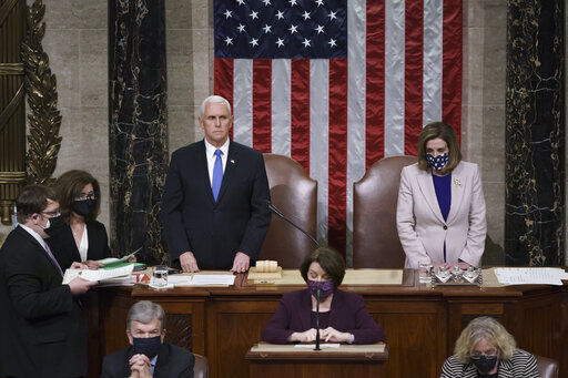 Vice President Mike Pence and Speaker of the House Nancy Pelosi, D-Calif., read the final certification of Electoral College votes cast in November