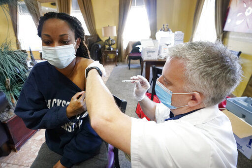 Walgreens pharmacist Chris McLaurin prepares to vaccinate Lakandra McNealy, a Harmony Court Assisted Living employee, with the Pfizer-BioNTech COVID-19 vaccine, Tuesday, Jan. 12, 2021, in Jackson, Miss. The Mississippi State Department of Health reports there have been 9,796 cases of the coronavirus in long-term care facilities and 1,791 deaths as of Tuesday. (AP Photo/Rogelio V. Solis) PHOTO CREDIT: Rogelio V. Solis