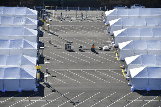 COVID-19 vaccination tents are set up in the north of the Toy Story parking lot at the Disneyland Resort on Tuesday, Jan. 12, 2021, in Anaheim, Calif. The parking lot is located off Katella Avenue and sits southeast of Disneyland. (Jeff Gritchen/The Orange County Register via AP) PHOTO CREDIT: Jeff Gritchen