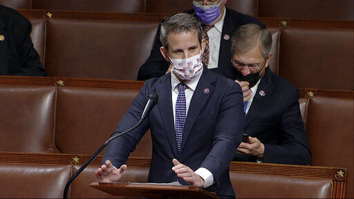 Rep. Adam Kinzinger, R-Ill., speaks in the House of Representatives. The House has opened its proceedings today, poised to impeach President Donald Trump for a second time exactly a week after his supporters stormed the Capitol to protest his election defeat. PHOTO CREDIT: House Television via AP