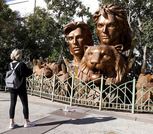 Bree Medin of Andover, Minn., takes a photo of a statue of Siegfried & Roy on the Strip in front of The Mirage in Las Vegas, Thursday, Jan. 14, 2021. Fischbacher, namesake partner in the iconic entertainment duo Siegfried & Roy, has died in Las Vegas at age 81. Fischbacher died Wednesday, Jan. 13, at his home from pancreatic cancer, said publicist Dave Kirvin of Kirvin Doak Communications. (K.M. Cannon/Las Vegas Review-Journal via AP) PHOTO CREDIT: K.M. Cannon