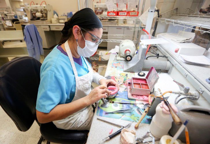 Claudia Gabriel works on a removable oral prosthetic at Oral Arts Dental Laboratory. The Dubuque business works with dentists to create a variety of items, such as crowns or replacement teeth, for patients. PHOTO CREDIT: NICKI KOHL