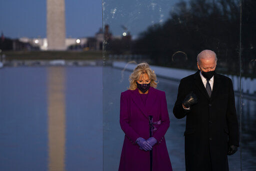 President-elect Joe Biden and his wife Jill Biden participate in a COVID-19 memorial event at the Lincoln Memorial Reflecting Pool Tuesday. In his first hours as president, Biden will aim to strike at the heart of President Donald Trump’s policy legacy, signing a series of executive actions that reverse his predecessor’s orders on immigration, climate change and handling of the coronavirus pandemic. PHOTO CREDIT: Evan Vucci
