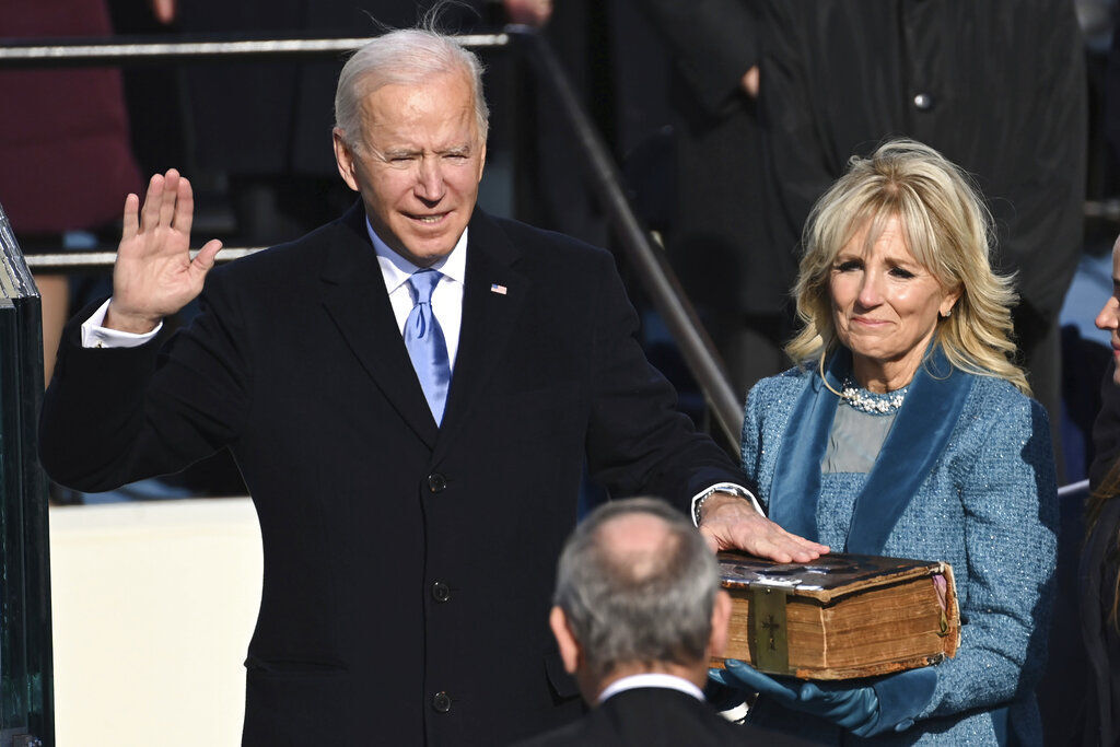 Joe Biden is sworn in as the 46th president of the United States by Chief Justice John Roberts as Jill Biden holds the Bible during the 59th Presidential Inauguration at the U.S. Capitol in Washington. PHOTO CREDIT: Saul Loeb