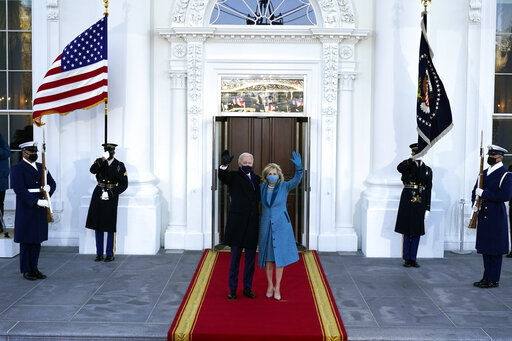 President Joe Biden and first lady Jill Biden wave as they arrive at the North Portico of the White House, Wednesday, Jan. 20, 2021, in Washington. (AP Photo/Alex Brandon, Pool) PHOTO CREDIT: Alex Brandon