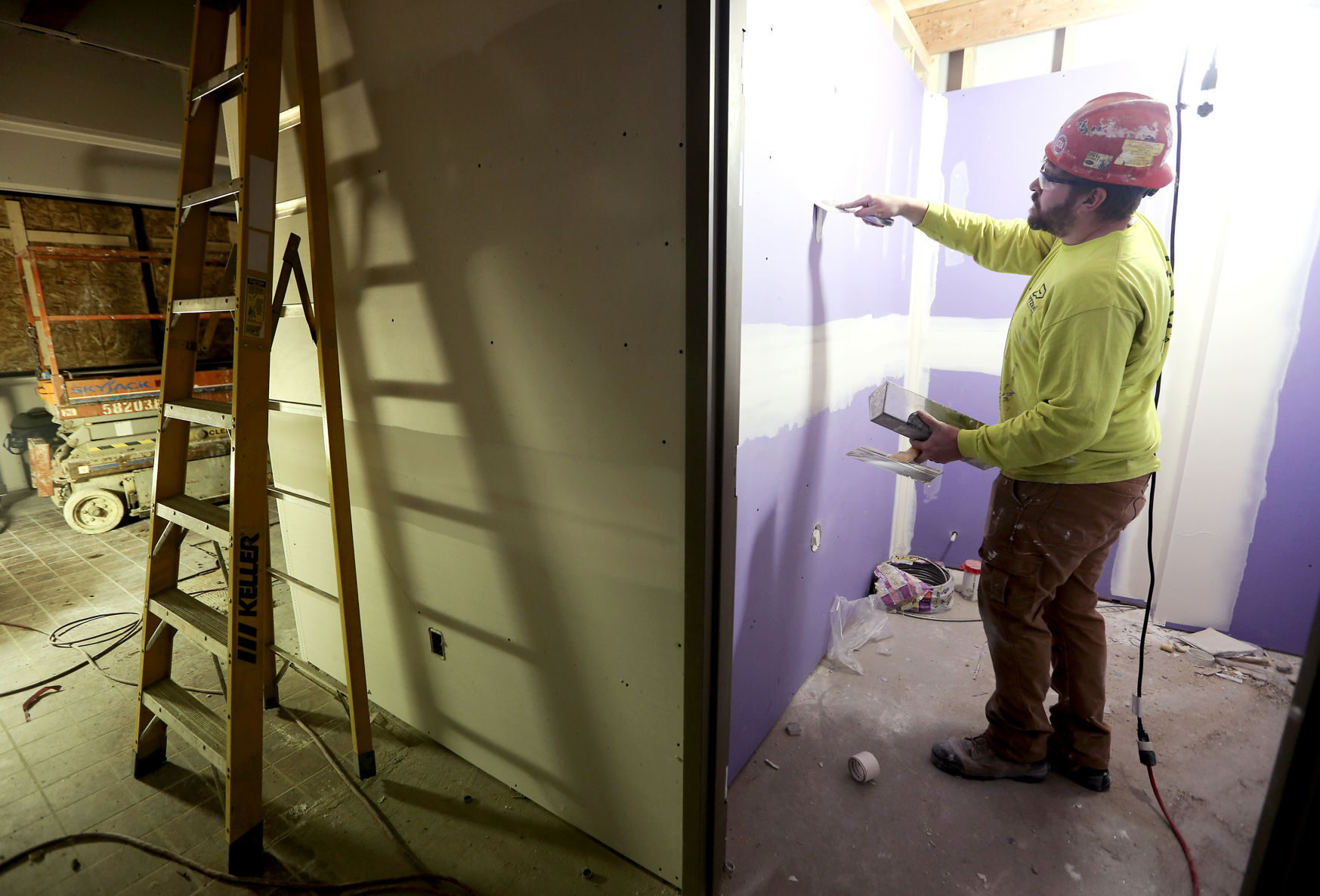 Dominic Watters, with Portzen Construction, works on a new bathroom as part of a renovation at Family Mart in Dubuque on Monday, Jan. 25, 2021. PHOTO CREDIT: NICKI KOHL