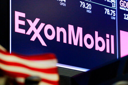 FILE - In this April 23, 2018, file photo, the logo for ExxonMobil appears above a trading post on the floor of the New York Stock Exchange. With all of the challenges of 2020, ExxonMobil focused on clamping down on expenses and managed to bring its full-year spending down nearly $10 billion from the year before. (AP Photo/Richard Drew, File) PHOTO CREDIT: Richard Drew