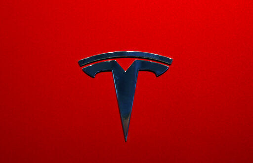 FILE- This Oct. 3, 2018, file photo shows a Tesla logo at an auto show in Paris. After refusing a request from U.S. safety regulators, Tesla has now agreed to recall about 135,000 vehicles because the large touch screens can go dark. The electric car company says it will recall certain 2012 through 2018 Model S sedans and 2016 through 2018 Model X SUVs to fix the problem. (AP Photo/Christophe Ena, File) PHOTO CREDIT: Christophe Ena
