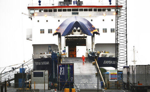A P&O worker closes the gate on the European Causeway ferry from Scotland in the port of Larne, Northern Ireland, Tuesday, Feb. 2, 2021. Authorities in Northern Ireland have suspended post-Brexit border checks on animal products and withdrawn workers after threats against border staff.(AP Photo/Peter Morrison) PHOTO CREDIT: Peter Morrison