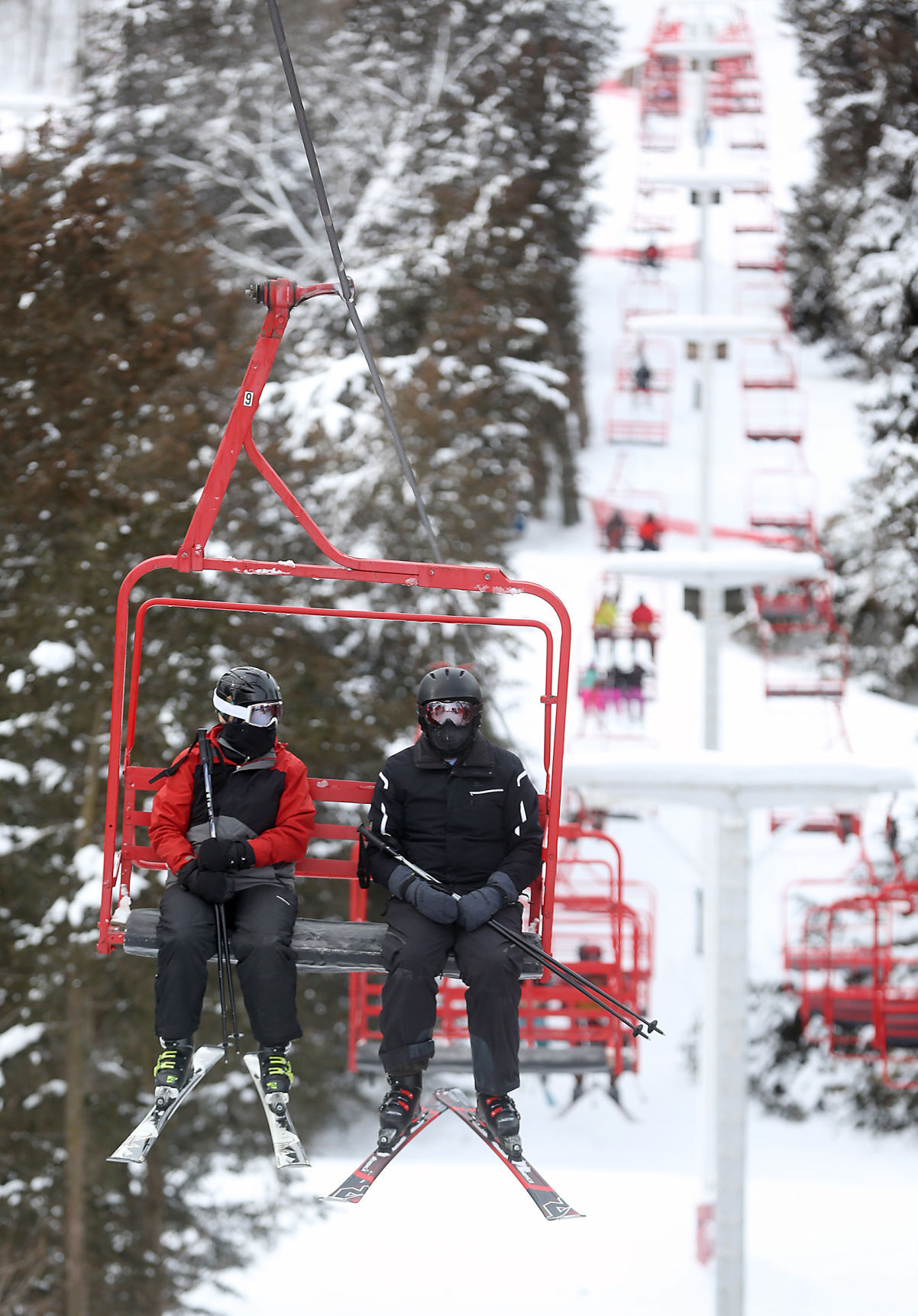 Skiers use a chairlift at Sundown Mountain Resort in rural Dubuque on Sunday. PHOTO CREDIT: JESSICA REILLY