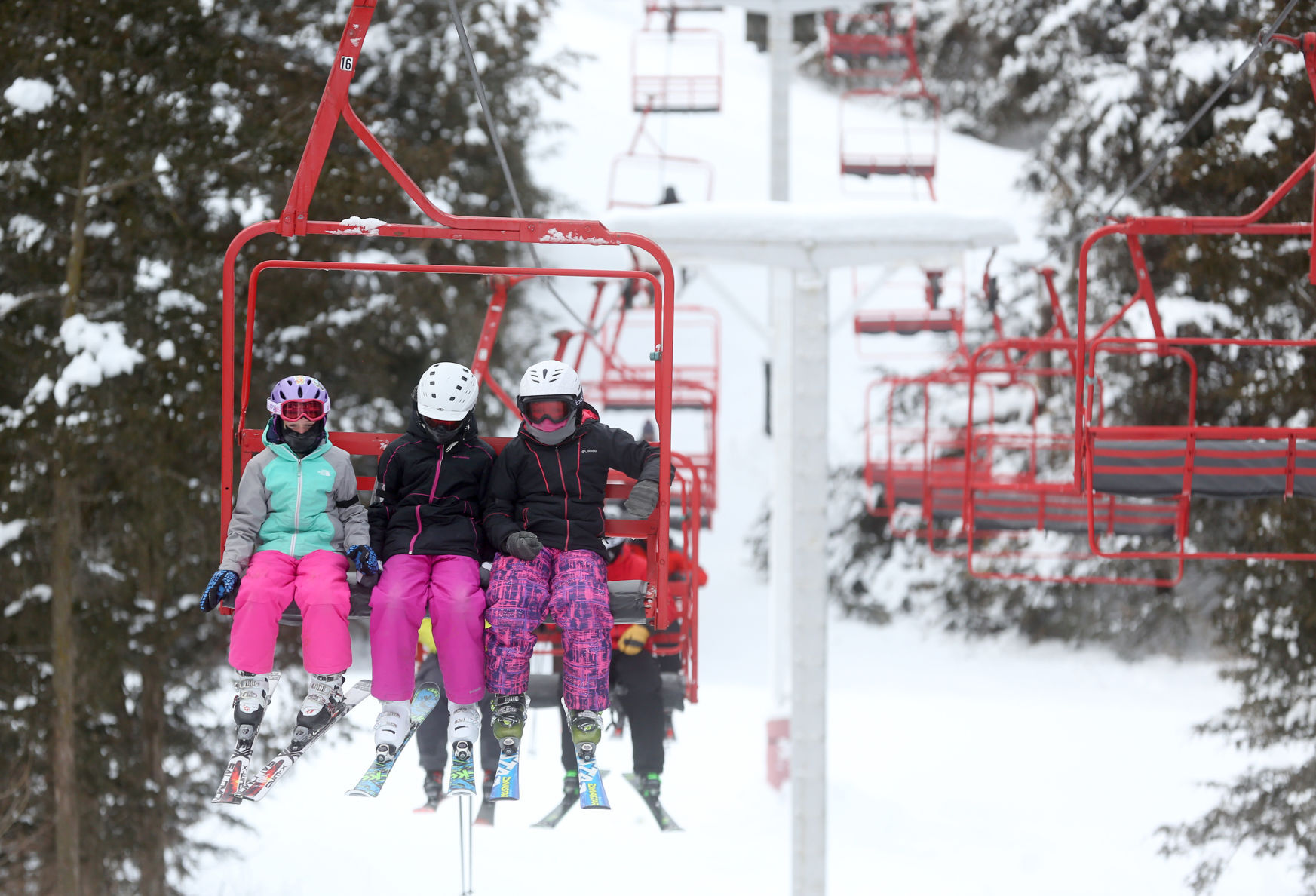 Skiers take a chair lift at Sundown Mountain Resort in rural Dubuque on Sunday, Feb. 7, 2021. PHOTO CREDIT: JESSICA REILLY