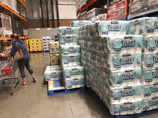 A shopper loads her basket next to a display of paper towels in a Costco warehouse in this photograph taken Wednesday, Nov. 18, 2020, in Sheridan, Colo. U.S. consumer prices edged up 0.2% in November as a rise in energy costs and variety of other items offset a drop in food costs. The Labor Department reported on Thursday, Dec. 10, that the gain in the consumer price index followed an unchanged reading in October and matched the 0.2% September advance. (AP Photo/David Zalubowski) PHOTO CREDIT: David Zalubowski
