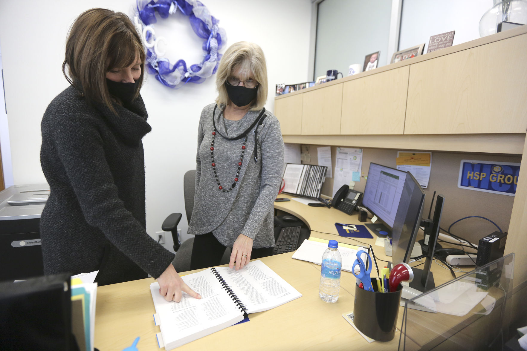 Katie Gilbert (left) works with staff member Janet Smith. PHOTO CREDIT: Dave Kettering