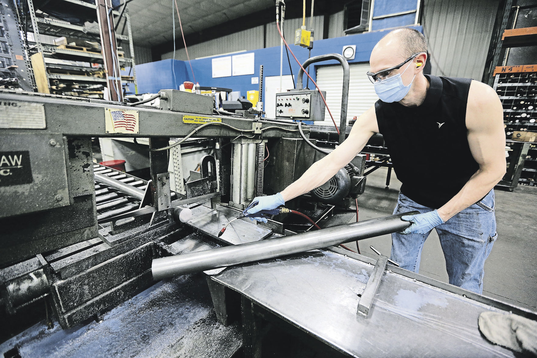 Darrell Schmitt, a saw operator at Dubuque Screw Products, works on a product. The company started 75 years ago. It moved to its Chavenelle Road site in 2008.    PHOTO CREDIT: Dave Kettering