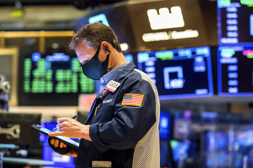 In this photo provided by the New York Stock Exchange, trader Robert Charmak works on the floor, Monday, March 1, 2021. Stocks are rising across the board on Wall Street as traders welcomed a move lower in long-term interest rates in the bond market. Investors were also watching Washington as a big economic stimulus bill moved to the Senate. (Courtney Crow/New York Stock Exchange via AP) PHOTO CREDIT: Courtney Crow