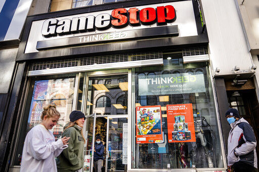 FILE - In this Jan. 28, 2021, file photo, pedestrians pass a GameStop store on 14th Street at Union Square, in the Manhattan borough of New York. The recent GameStop frenzy provided what parents and educators call a teachable moment - an opportunity that presents itself to lend a little insight. The Associated Press talked to a few parents and financial experts for their tips, and included in their advice was teaching kids early on about money, keeping the discussions simple but interesting and letting kids practice investing. (AP Photo/John Minchillo, File) PHOTO CREDIT: John Minchillo