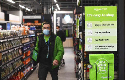The Amazon Fresh grocery store opens in London today where a sign explains for shoppers to pick up items and walk out of the store, contactless, without the need for a till. Customers will scan a QR code on their way into the store, with cameras and technology identifying the items that shoppers take from the shelves and their account automatically paid.  PHOTO CREDIT: Victoria Jones