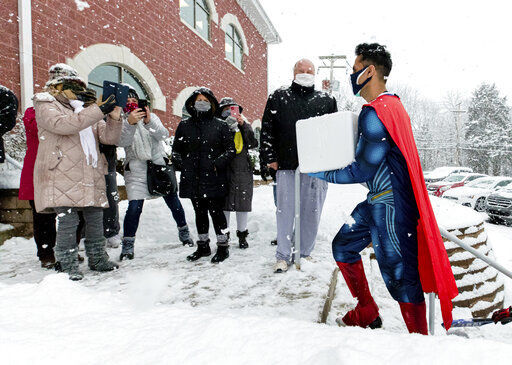 Skippack Pharmacy owner & Pharmacist Dr. Mayank Amin, dressed in his trademark superhero costume, arrives in the middle of a snowstorm with vials of COVID-19 vaccine for their first vaccination clinic on Feb. 7, 2021, in Skippack, Pa. In communities across the country, local pharmacy owners are among the people administering COVID-19 vaccinations.  PHOTO CREDIT: Chorus Media Group