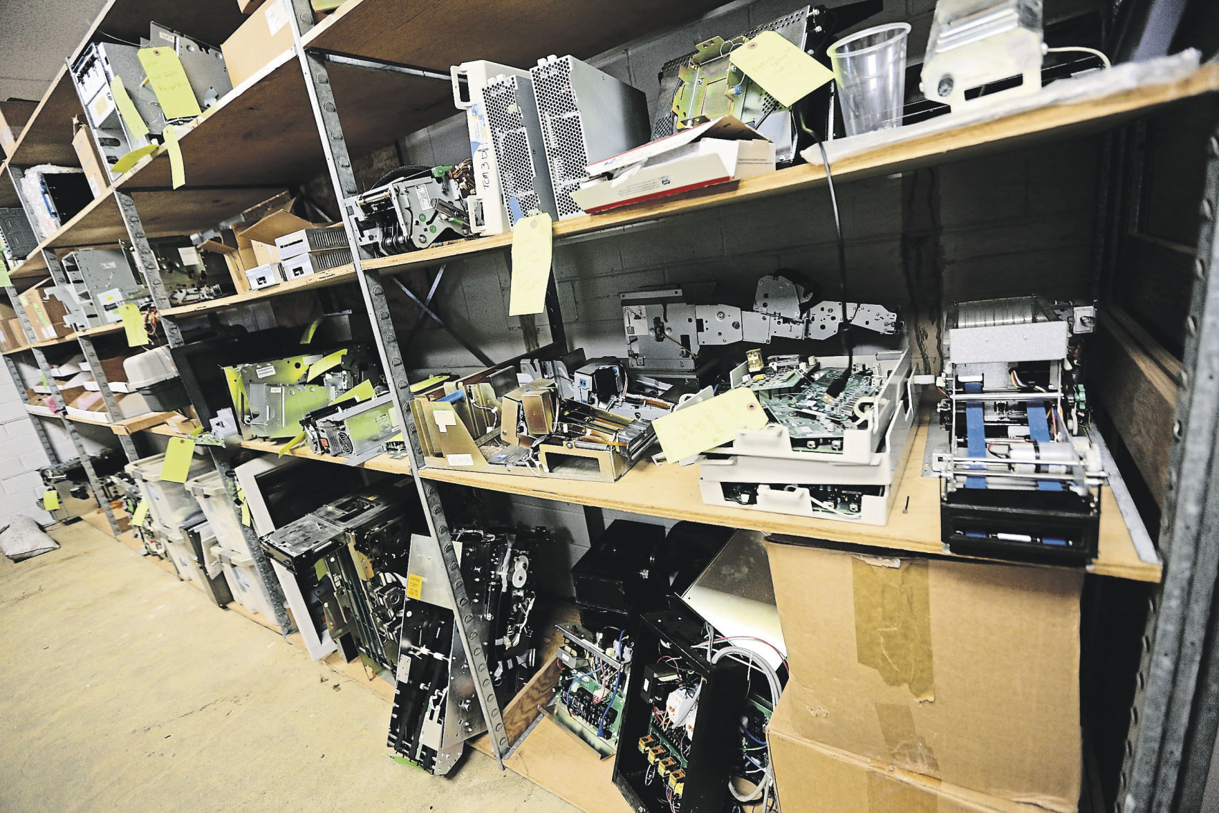 A collection of ATM parts used to service products are kept in storage. PHOTO CREDIT: Dave Kettering