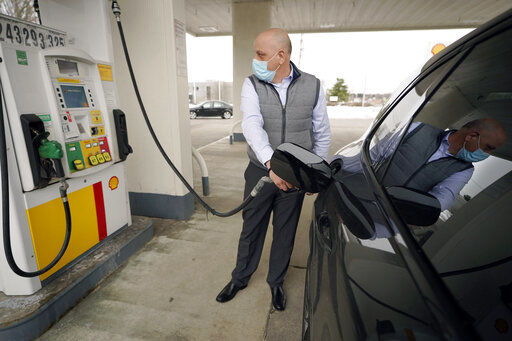 FILE - In this Thursday, Feb. 18, 2021 file photo, Jeremy Heskett, of Boston, pumps gasoline at a Shell gas station, in Westwood, Mass. U.S. consumer prices increased 0.4% in February, the biggest increase in six months, led by a sharp jump in gasoline prices. The Labor Department said Wednesday, March 10 that the February advance in its consumer price index followed a 0.3% rise in January and was the largest advance since a similar 0.4% increase in August. (AP Photo/Steven Senne, File) PHOTO CREDIT: Steven Senne