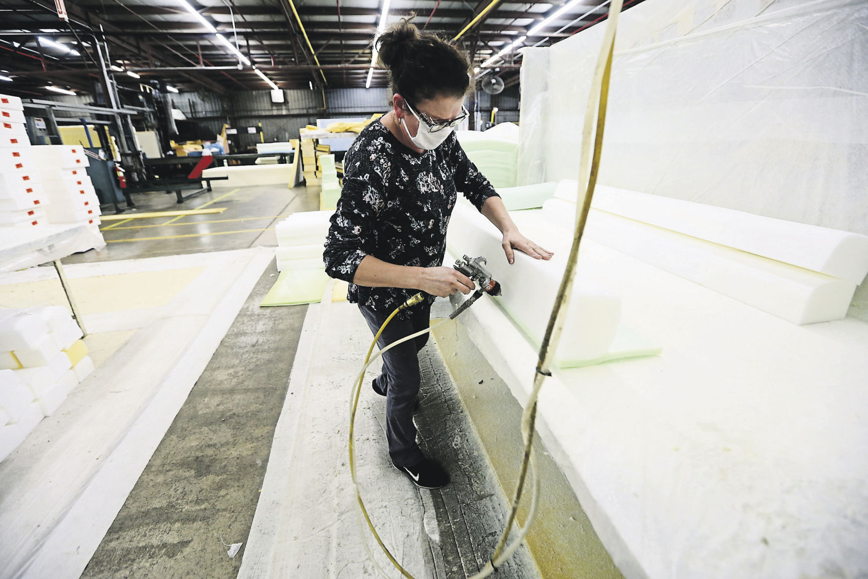 Zehida Covic assembles product at FXI. The manufacturing facility in Dubuque has shown growth since falling on some difficult times. FXI has adjusted and expanded its footprint to become one of the top polyurethane foam makers in North America. PHOTO CREDIT: NICKI KOHL