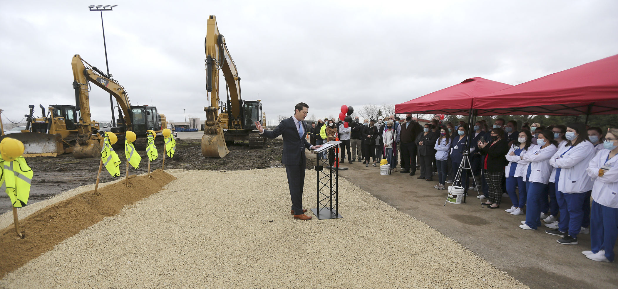 Wes Schulte, of College Suites LLC, speaks Thursday during a groundbreaking for the College Suites development that will be constructed on the edge of the Northeast Iowa Community College campus in Peosta, Iowa. PHOTO CREDIT: Dave Kettering