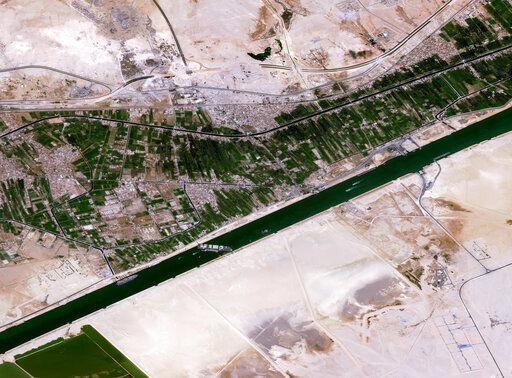 This satellite image from Cnes2021, Distribution Airbus DS, shows the cargo ship MV Ever Given stuck in the Suez Canal near Suez, Egypt, Thursday, March 25, 2021. The skyscraper-sized cargo ship wedged across Egypt