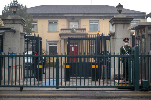 A Chinese paramilitary police officer stands guard outside the British Embassy in Beijing, Friday, March 26, 2021. China has announced sanctions on British individuals and entities following the U.K.