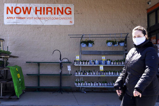 A hiring sign is seen outside home improvement store in Mount Prospect, Ill. The number of Americans applying for unemployment benefits rose last week to 744,000, signaling that many employers are still cutting jobs even as more people are vaccinated against COVID-19, consumers gain confidence and the government distributes aid throughout the economy. PHOTO CREDIT: Nam Y. Huh