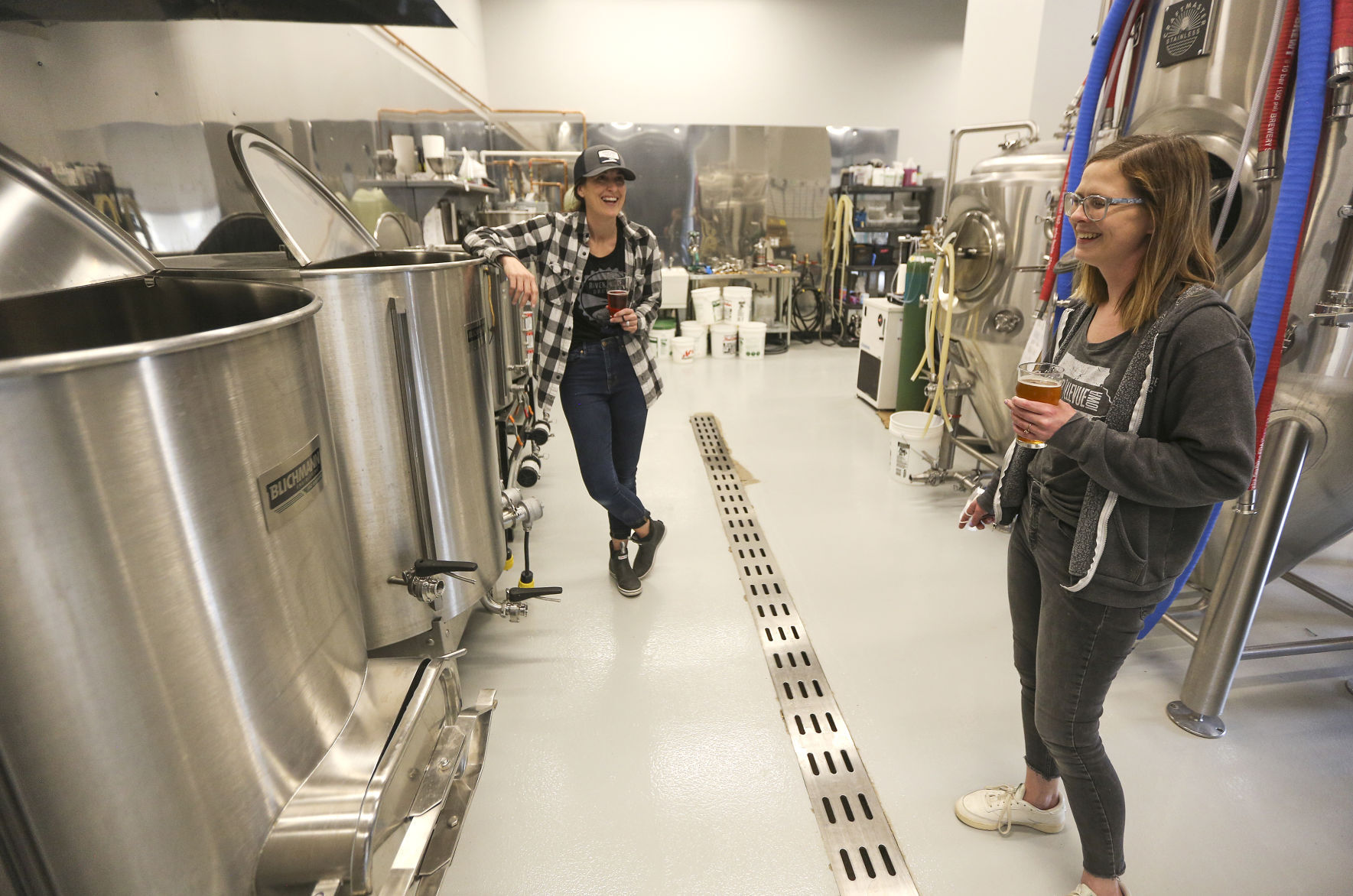 Co-owners of River Ridge Brewing, Kelly Hueneke (left) and Allison Simpson, chat in their brewing area of their new business located in Bellevue, Iowa. PHOTO CREDIT: Dave Kettering