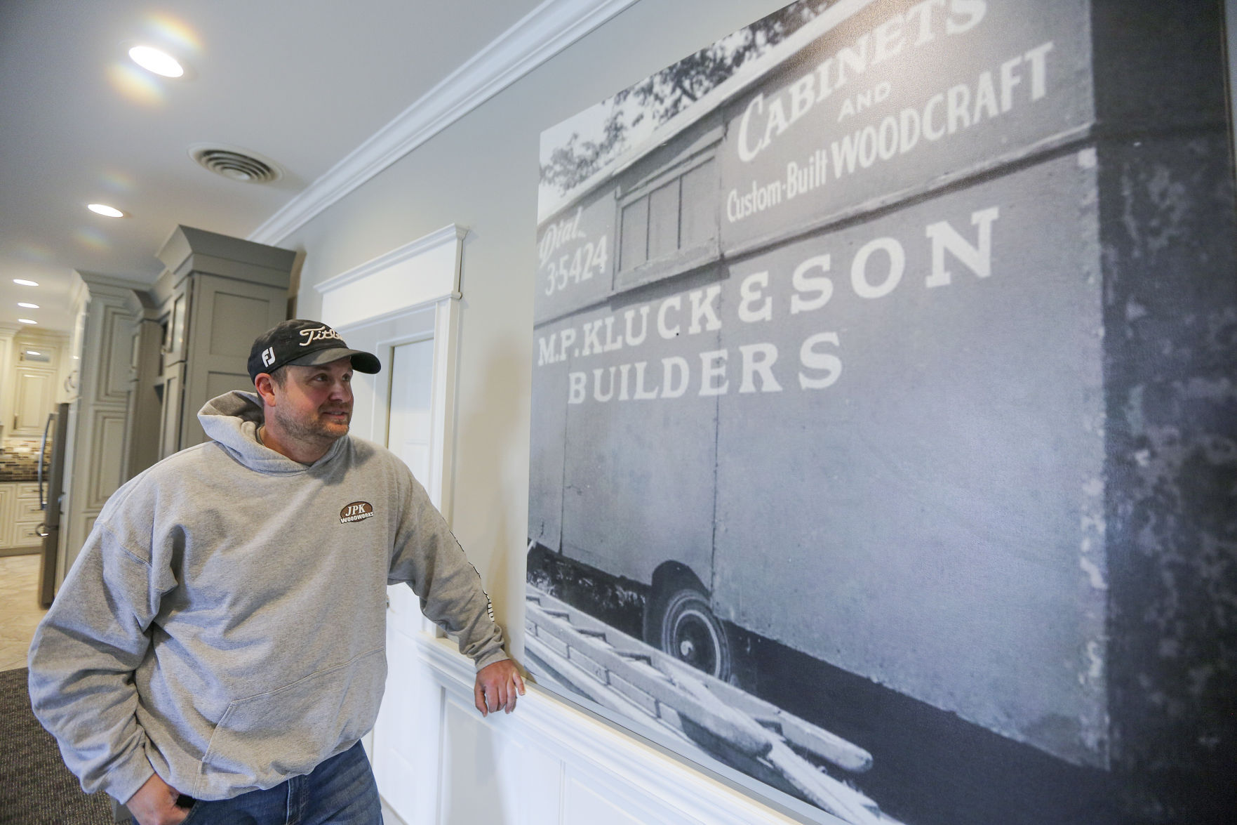 Owner of JPK Woodworks in Dubuque, Jon Kluck looks over a display for the business his grandfather started.    PHOTO CREDIT: Dave Kettering