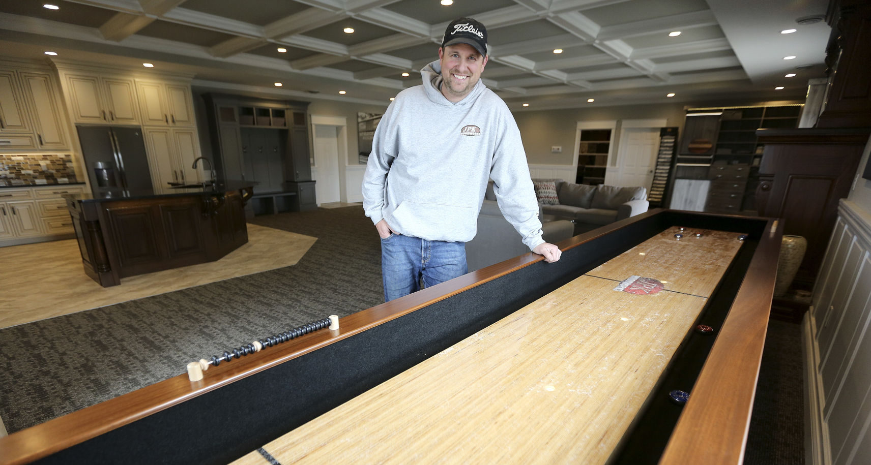 Jon Kluck, owner of JPK Woodworks, stands in his showroom Monday at 8005 Seippel Court in Dubuque. PHOTO CREDIT: Dave Kettering