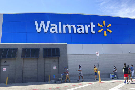 Customers wait in line outside a Walmart Supercenter store, due to COVID-19 restrictions on store capacity, Wednesday, April 7, 2021, in Miami. Walmart is moving more of its workers full time, with the goal of having two-thirds of its U.S. store hourly jobs be full-time with more consistent work schedules by early next year. With this move, announced Wednesday, April 14, the nation’s largest private employer says it will have 740,000 of its 1.2 million U.S. Walmart hourly store workers be full-time by Jan. 31. (AP Photo/Wilfredo Lee) PHOTO CREDIT: Wilfredo Lee
