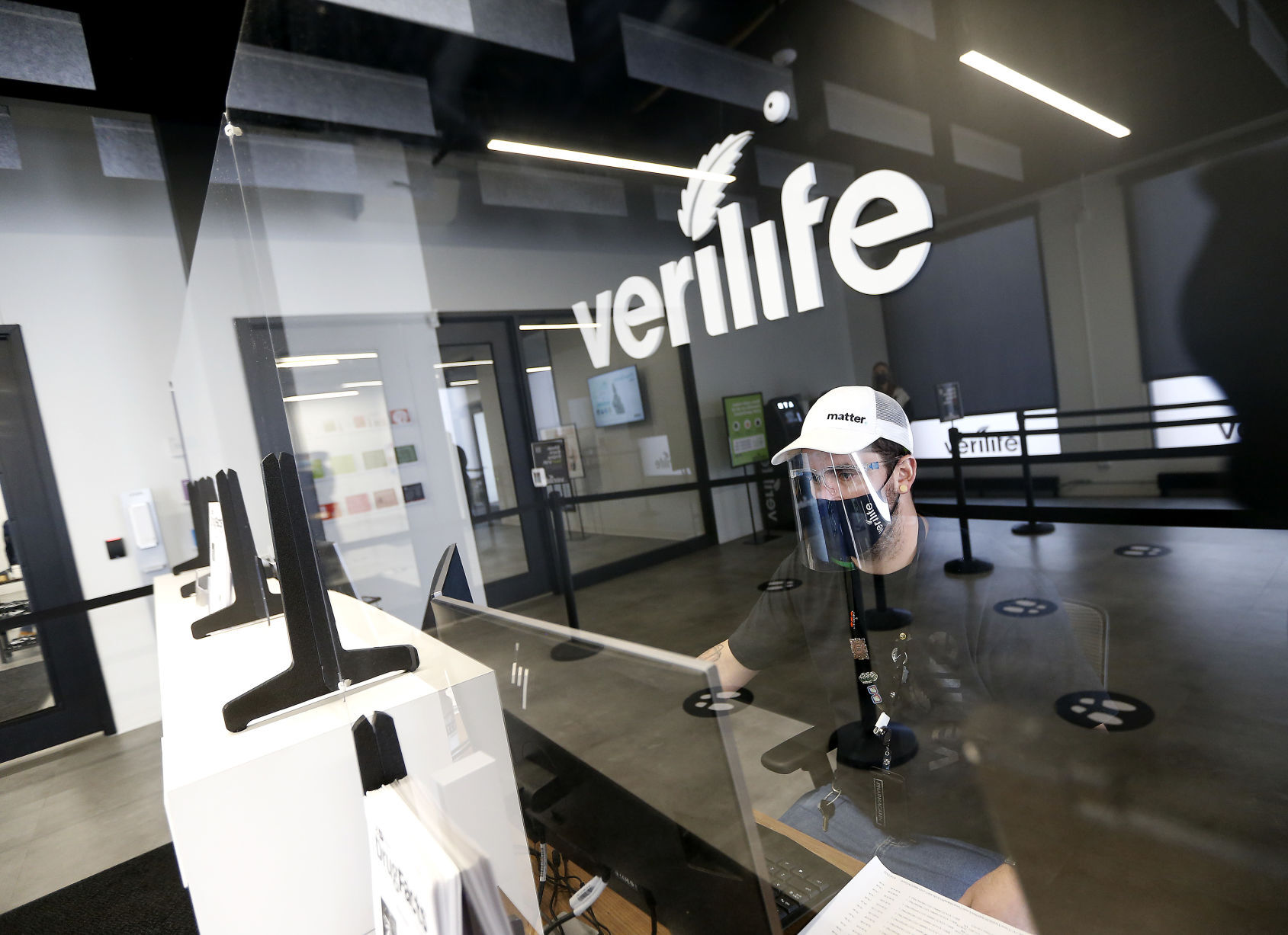 Sean Carter, associate with Verilife in Galena, Ill., works at the front desk of the dispensary on Wednesday. The Galena cannabis dispensary, part of a chain operated by PharmaCann, opened on March 6. PHOTO CREDIT: Dave Kettering