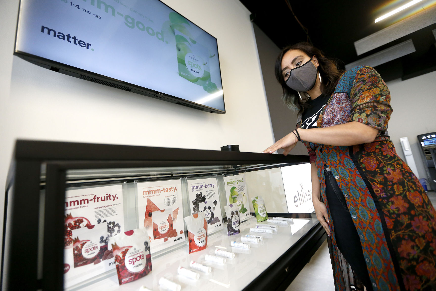 Divina Capellupo, Verilife district manager for the state of Illinois, shows some of the products offered at the dispensary in Galena, Ill., on Wednesday. PHOTO CREDIT: Dave Kettering