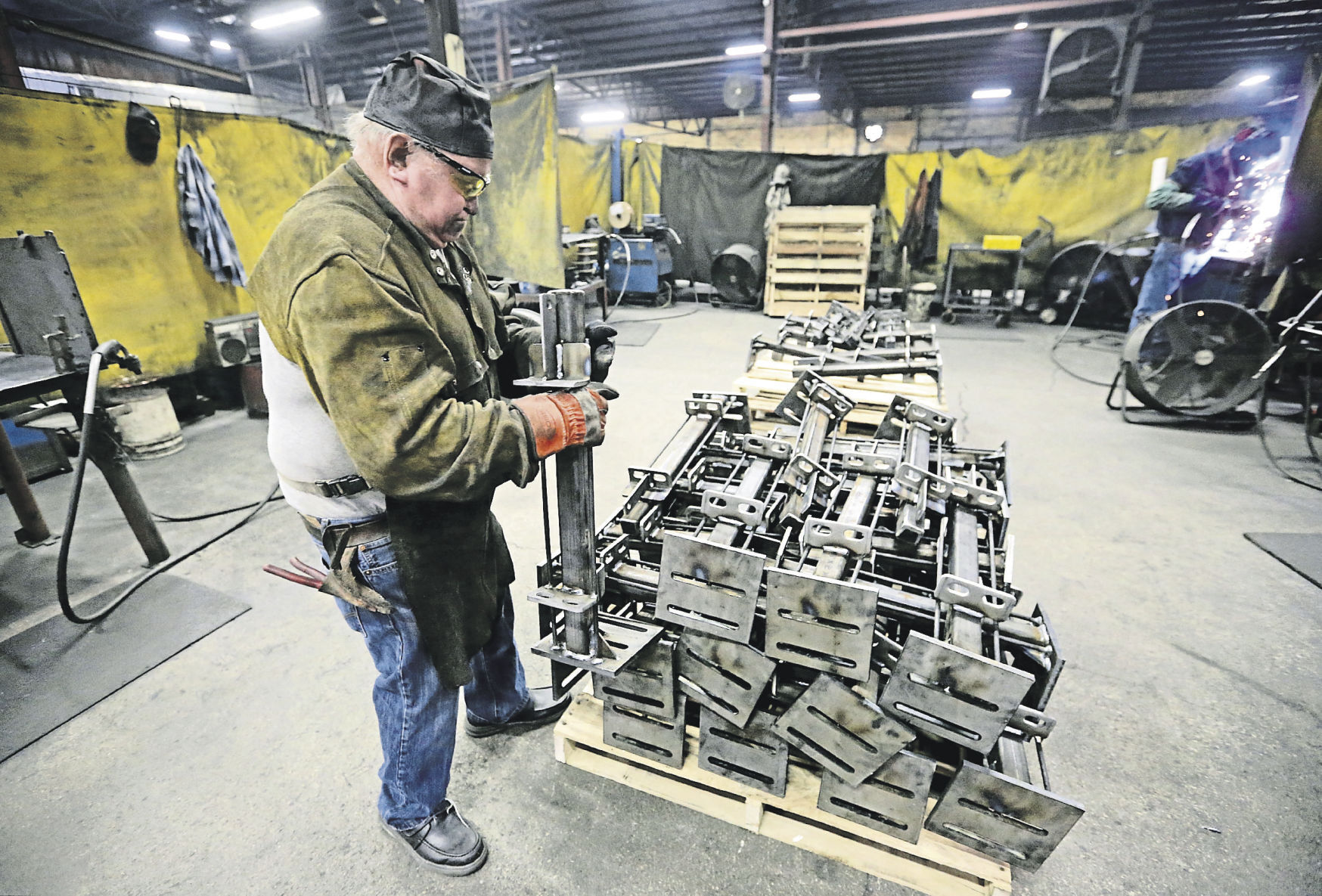 Jerry Ingles places a product on a pallet at EIP Manufacturing. The business has two locations in Earlville, Iowa. It creates custom-made products that are specific to the hog industry. It also is expanding its service area beyond the Midwest.    PHOTO CREDIT: JESSICA REILLY