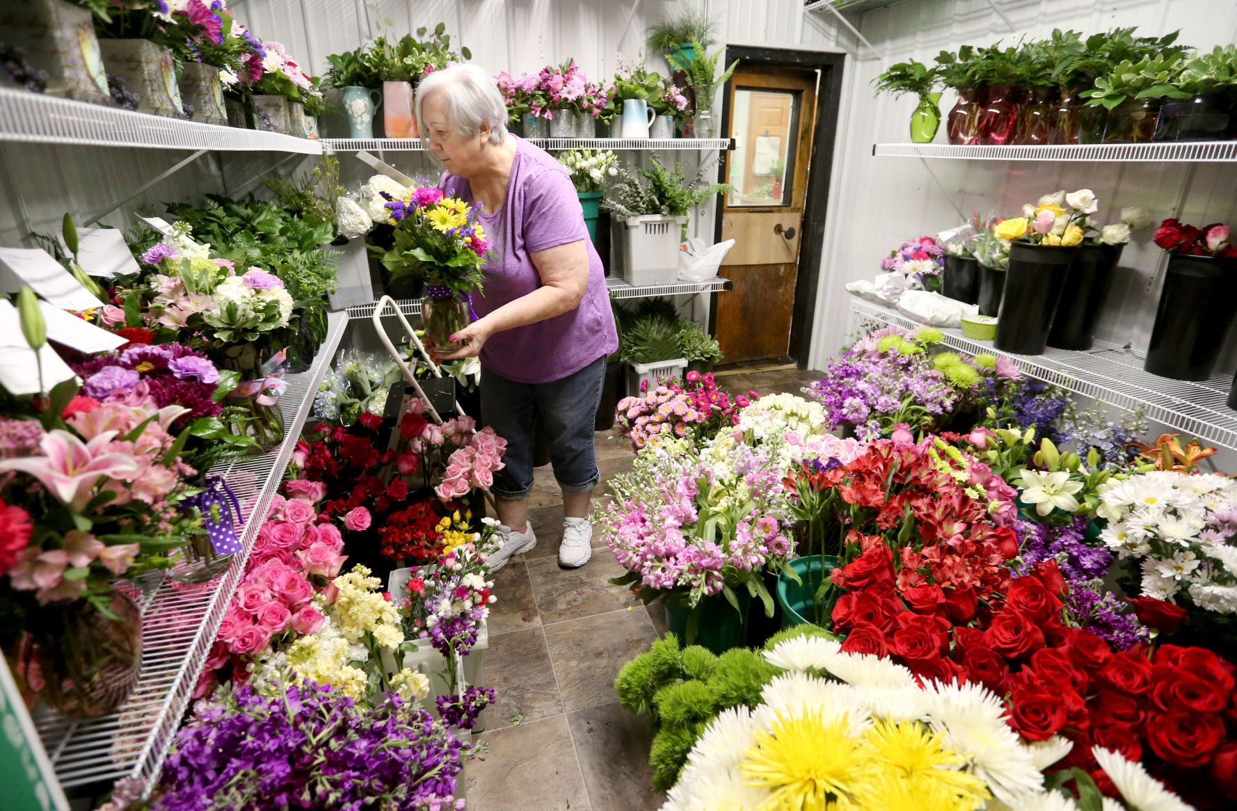Doretta Allen stores a flower arrangement at Butt