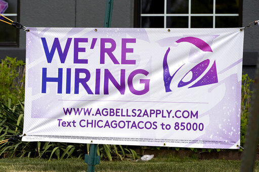 A hiring sign is displayed outside of a restaurant in Glenview, Ill. U.S. employers posted a record number of available jobs in March, illustrating starkly the desperation of businesses seeking to find new workers as the economy expands. PHOTO CREDIT: Nam Y. Huh