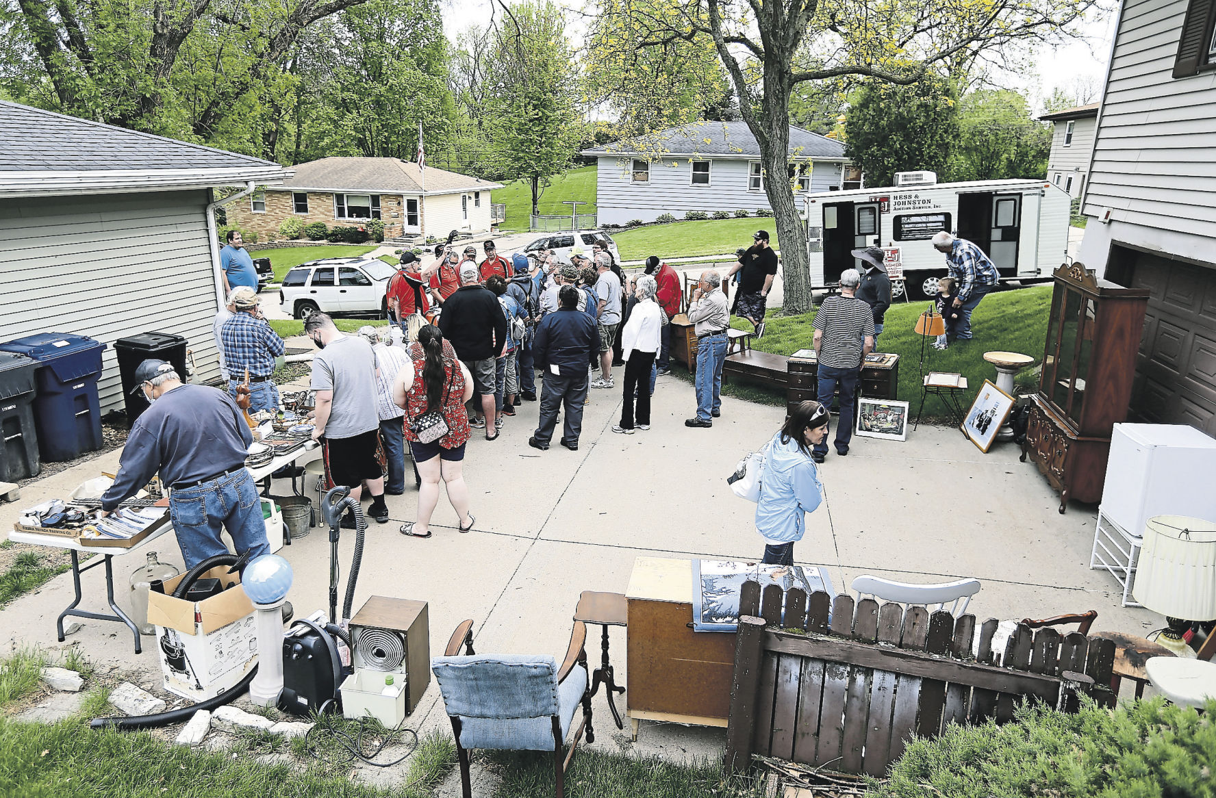 People look over items to bid on during an estate auction held in Dubuque. PHOTO CREDIT: Dave Kettering