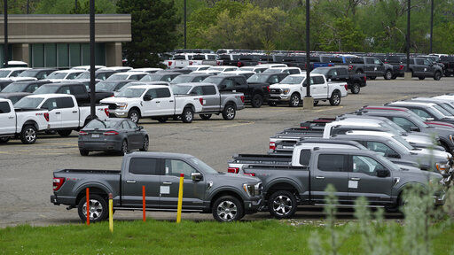 Ford pickup trucks built lacking computer chips are shown in parking lot storage in Dearborn, Mich., Tuesday, May 4, 2021. Automakers are cutting production as they grapple with a global shortage of computer chips, and that