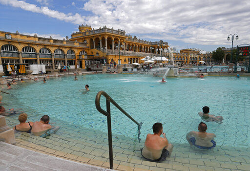 FILE - In this Saturday, May 1, 2021 file photo, people in the reopened Szechenyi bath in Budapest, Hungary. The European Union on Wednesday, May 19, 2021 took a step toward relaxing tourism travel for visitors from outside the bloc, with EU ambassadors agreeing on measures to allow fully vaccinated visitors in. They also agreed on easing the criteria for nations to be considered a safe country, from which all tourists can travel. Up to now, that list included only seven nations. (AP Photo/Laszlo Balogh, File) PHOTO CREDIT: Laszlo Balogh