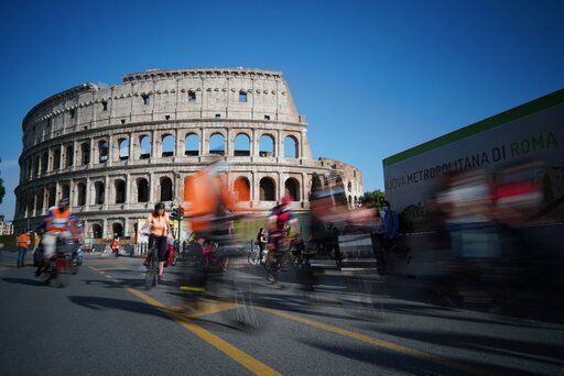 FILE - In this Friday, June 5, 2020 file photo, people cycle during a demonstration in front of the ancient Colosseum in Rome. The European Union on Wednesday, May 19, 2021 took a step toward relaxing tourism travel for visitors from outside the bloc, with EU ambassadors agreeing on measures to allow fully vaccinated visitors in. They also agreed on easing the criteria for nations to be considered a safe country, from which all tourists can travel. Up to now, that list included only seven nations. (AP Photo/Andrew Medichini, File) PHOTO CREDIT: Andrew Medichini