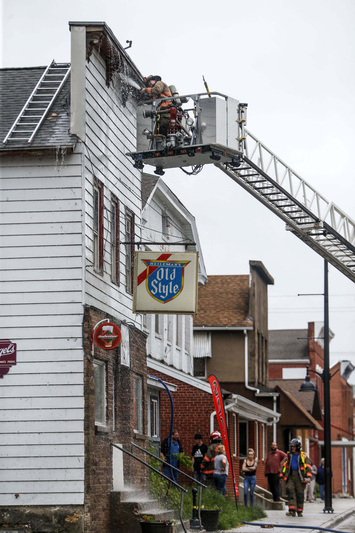 Firefighters look for hot spots after battling a blaze at 101 Jefferson St. in Hanover, Ill., on Wednesday, May 19, 2021. PHOTO CREDIT: Dave Kettering