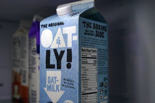 A carton of Oatly oat milk sits in a home refrigerator Tuesday, May 18, 2021, in Bellingham, Wash. Oatly, the world’s largest oat milk company, will raise $1.4 billion in an initial public offering Thursday, May 20 on the Nasdaq stock exchange. (AP Photo/Elaine Thompson) PHOTO CREDIT: Elaine Thompson