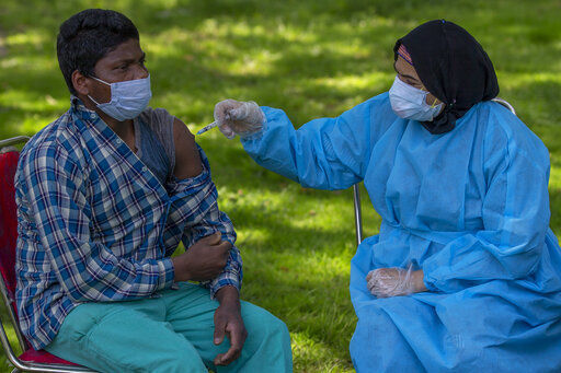 A health worker administers Covishield, Serum Institute of India