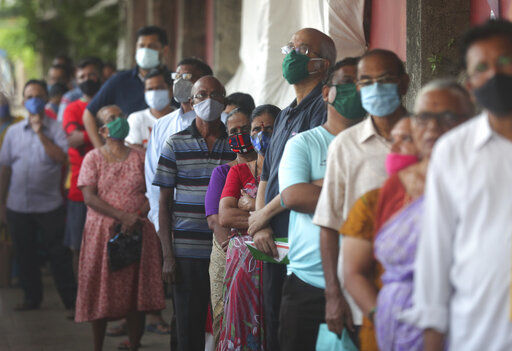 People wearing face masks as a precaution against the coronavirus line up to receive the vaccine for COVID-19 in Mumbai, India, Tuesday, May 25, 2021. (AP Photo/ Rafiq Maqbool) PHOTO CREDIT: Rafiq Maqbool