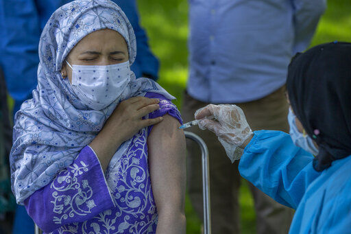 A health worker administers Covishield, Serum Institute of India