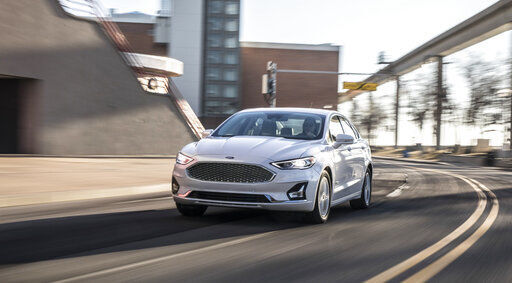 This photo provided by Ford shows a Ford Fusion Hybrid, a hybrid midsize sedan that is essentially a regular Fusion but with higher fuel economy. (Courtesy of Ford Motor Co. via AP) PHOTO CREDIT: HONS